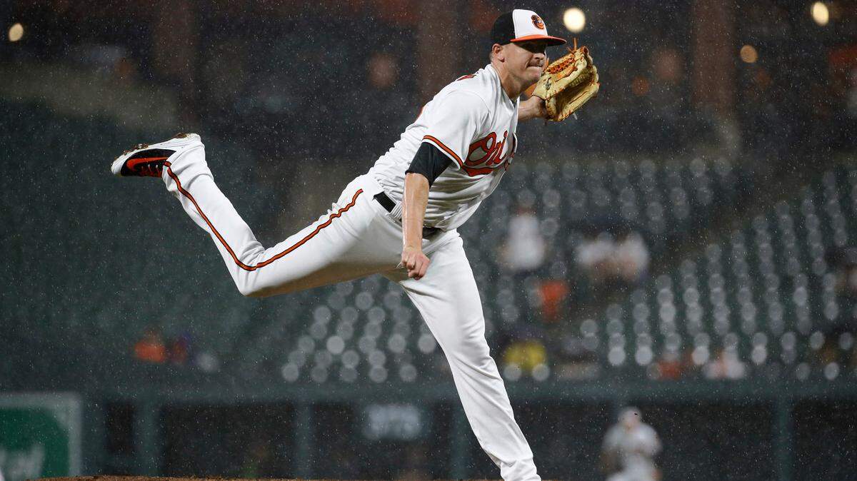 Baltimore Orioles relief pitcher Brad Brach follows through on a pitch to the Boston Red Sox in the ninth inning of a baseball game, Tuesday, July 24, 2018, in Baltimore