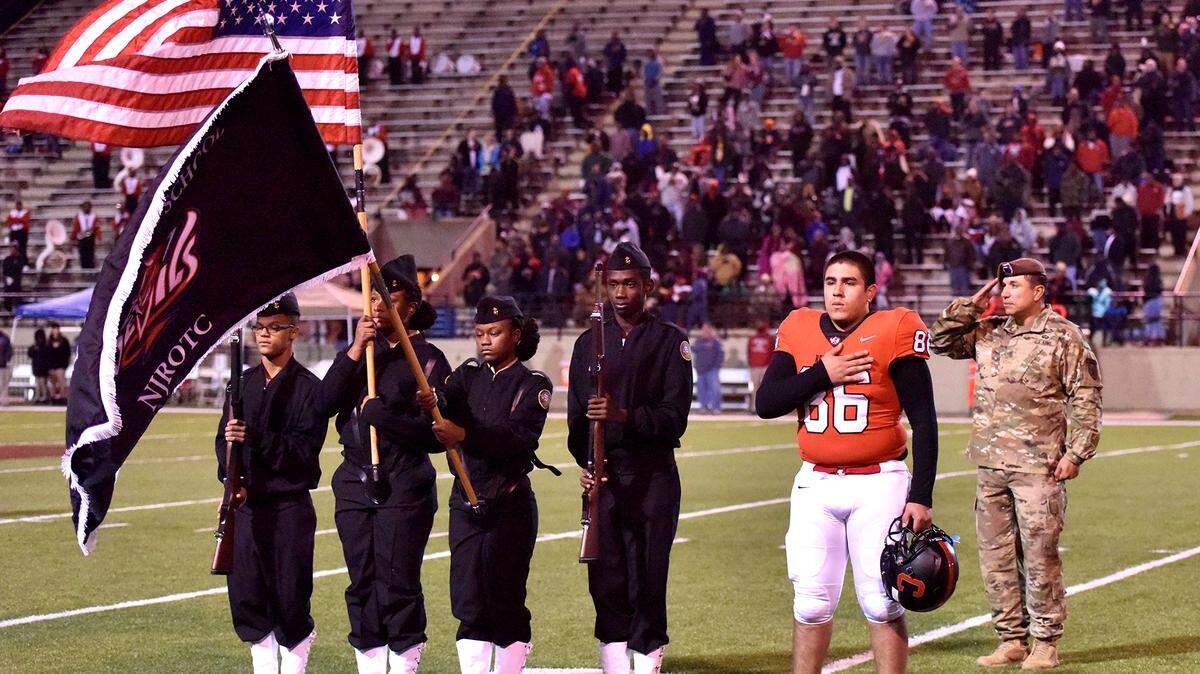 Central’s Angel Gil-Rodriguez is surprised by his father Sgt Major Jose Rodriguez who had just returned from his 7th tour of duty in Afghanistan during the presentation of the colors before the start of the play-off game against Lee General Friday night, November 23, 2018 