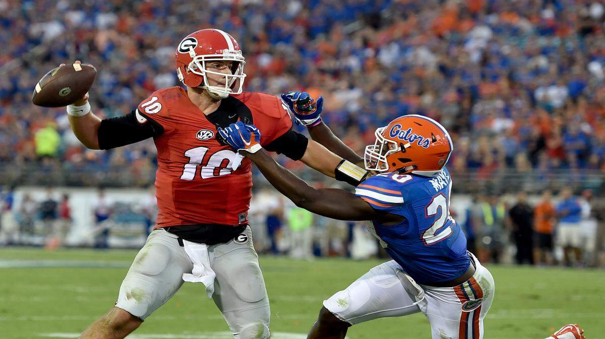 BRANT SANDERLIN/Atlanta Journal-Constitution via APGeorgia quarterback Faton Bauta throws under pressure from Florida defensive back Marcus Maye, resulting in an interception Saturday in Jacksonville, Fla.