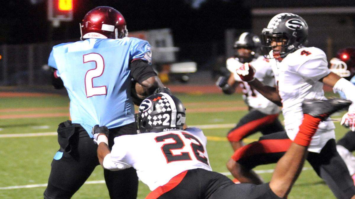 Carver's Jawon Pass breaking the tackle of Shaw's Devon Gailliard as he breaks the plane of the goal line for Carver's 2nd touch down of the night