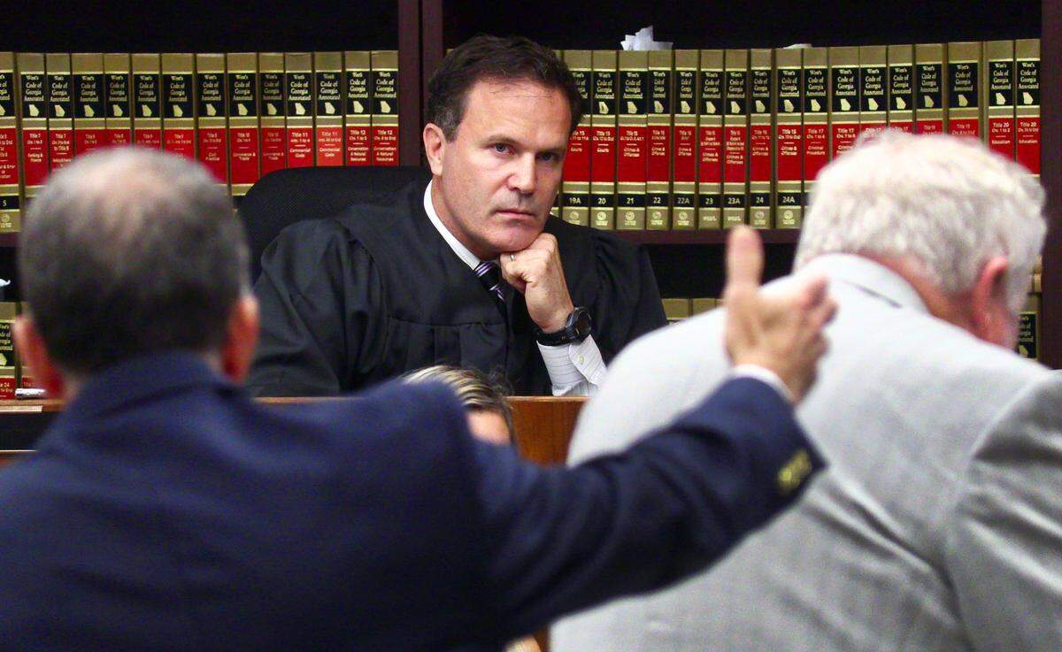 Superior Court Judge John Martin, center, listens Thursday morning to an argument from Assistant District Attorney Peter Hoffman, left, during the trial of Lydell Maynard “Trapa” Sparks. Sparks is being represented by Mike Garner, right. 06/16/2022