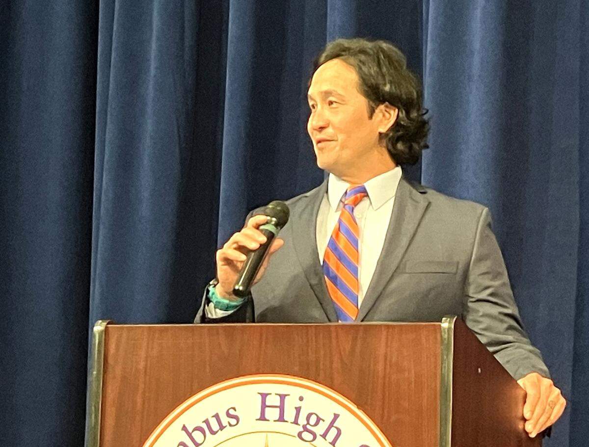 Robert “Bob” Peters speaks to the crowd Jan. 31, 2024, in the Columbus High School auditorium after he was announced as the new head coach of the football team.