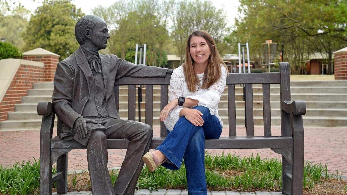 Rev. Ashley Brock Guthas in a photo taken on Mercer University’s Atlanta campus sitting next to a statue of Jesse Mercer, the schol’s namesake. Guthas is the new pastor for Maranatha Baptist Church in Plains, Georgia.