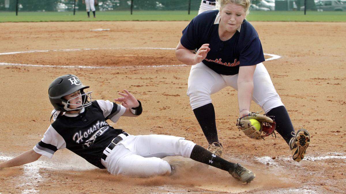 ROBIN TRIMARCHI rtrimarchi@ledger-enquirer.com 
 Northside High pitcher Allison Sievers misses the tag on Houston County's Jamie Benda in the opening round game of the GHSA state softball tournament Thursdsay at South Commons. 10.29.15