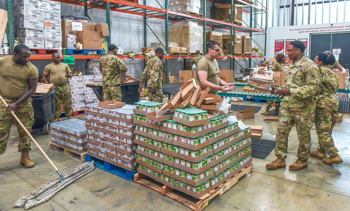 Soldiers with the National Guard 1230 Transportation Company from Thomasville, Georgia sort food donations at Feeding the Valley Food Bank on June 25, 2020. The unit was activated by Georgia Gov. Brian Kemp to replace regular volunteers who weren’t allowed to work because of the COVID 19 pandemic.