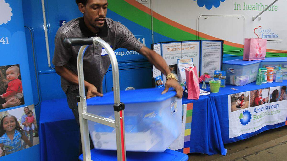 Adonis Williamson loads school supplies onto a hand truck Tuesday morning after representatives from Amerigroup Community Care of Georgia presented the supplies to representatives from Rigdon Road Elementary School as part of Amerigroup's new iniative called "Teacher Supply Closet."