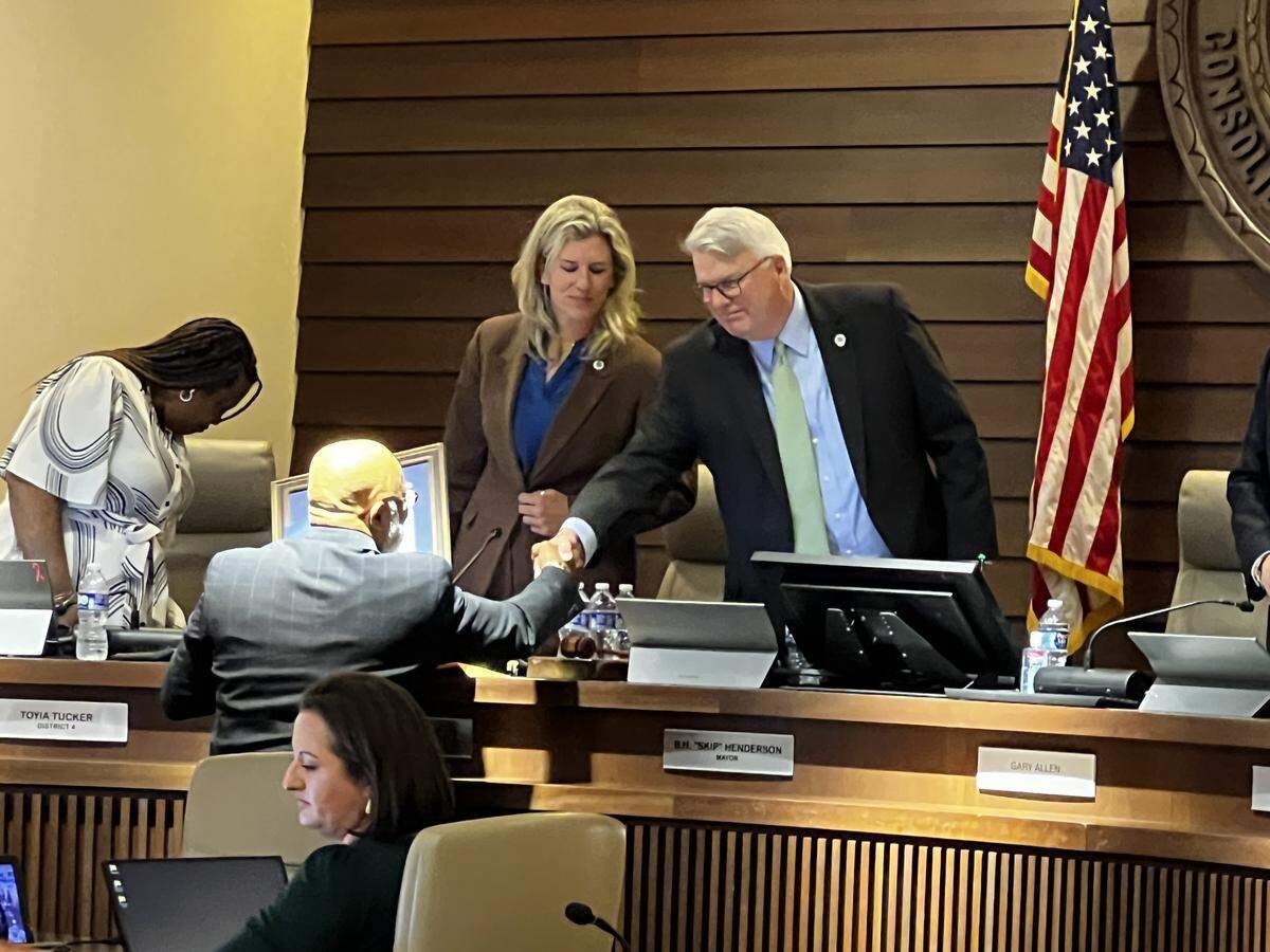 During the May 26, 2026, Columbus Council meeting, former Councilor Byron Hickey shakes hands with Mayor Skip Henderson after completing his time serving on the council. The council proclaimed the day as Byron Hickey Appreciation Day.