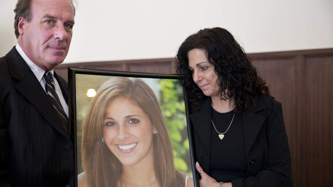 Jim Burk, left, and Viviane Guerschon, right, attend a State Board of Adjustment hearing with a portrait of their daughter Lauren Burk, Tuesday, Oct. 7, 2014, in Montgomery, Ala. Lauren Burk was abducted from an Auburn University campus parking lot and killed in March 2008. Courtney L. Lockhart was convicted in her murder and sentenced to death.