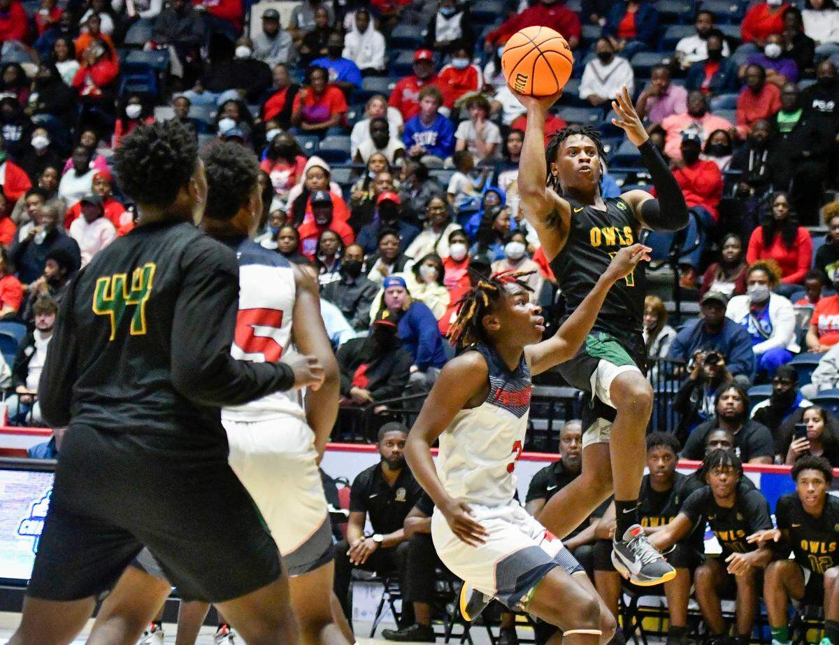 Spencer’s Randall Dixon (4) puts up a shot over a Westover defender during the GHSA 4A State Championship game Wednesday in Macon.