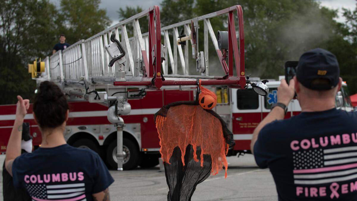 Firefighter Jenny Baldwin and Captain Kevin Alford affix a Halloween dummy to the top of a firetruck during the Spooktacular Trunk or Treat event on Sunday, Oct. 25, 2020 at the Civic Center in Columbus.