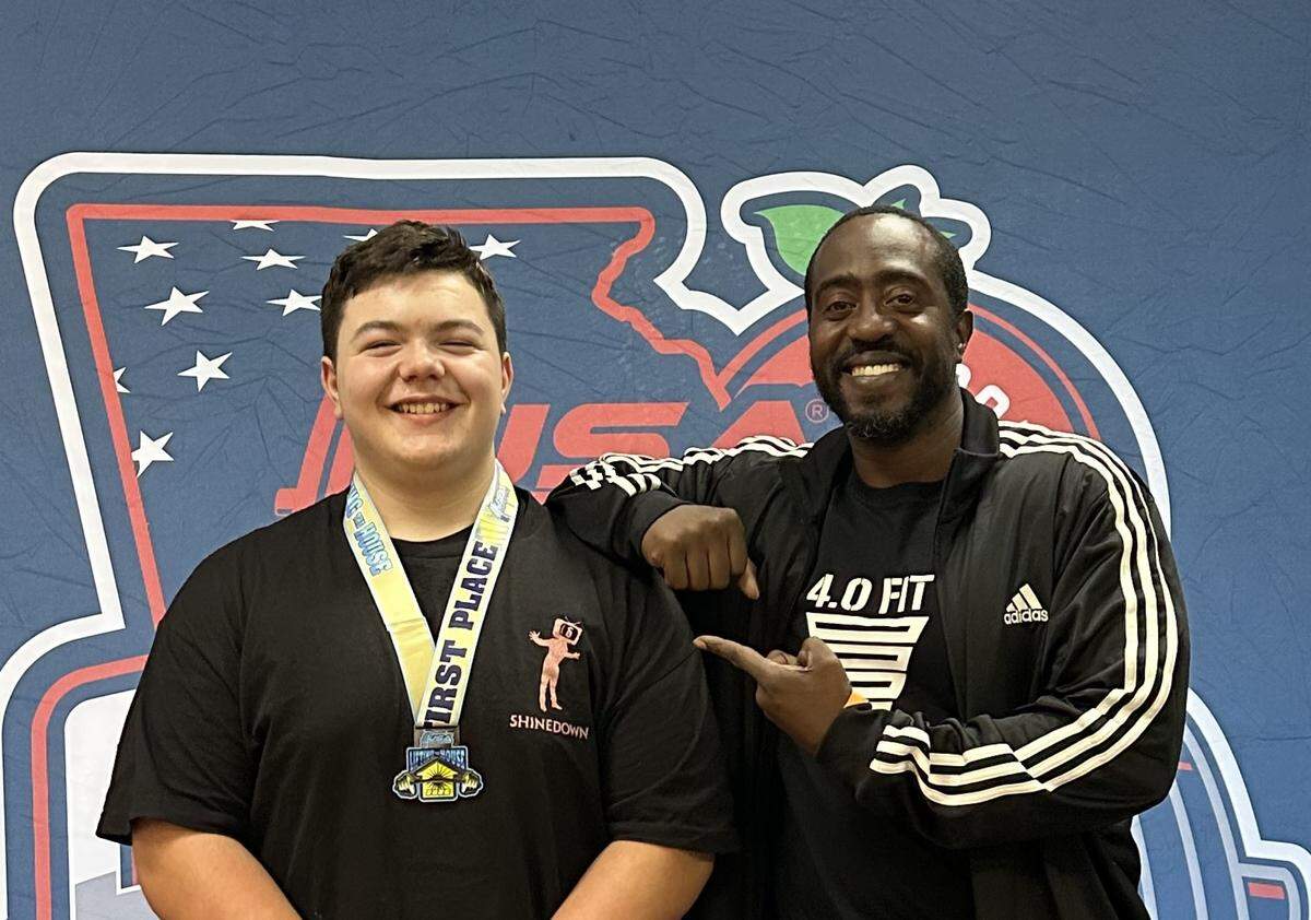 Nash Earwood, 12, of Columbus, poses with his strength coach, Terrence Flowers, who owns the Columbus gym called 4.0 Fitness. Nash setting three state records for his age group Sept. 13, 2025, at the USA Powerlifting event in Ringgold, Georgia.