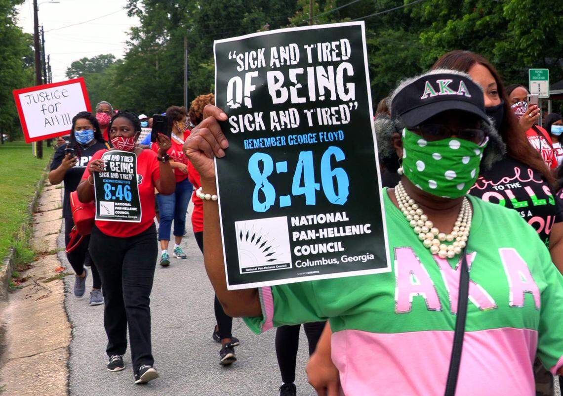 Protesters march to the Columbus Government Center Saturday morning.