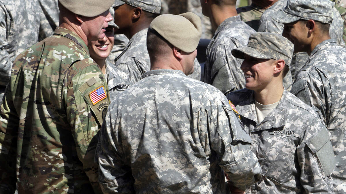 ROBIN TRIMARCHI rtrimarchi@ledger-enquirer.comCapt. Kristen Griest, left, and 1st Lt. Shaye Haver are congratulated by senior officers during Ranger School graduation ceremonies at Victory Pond Friday. The two women are the first female soldiers to earn and wear the Ranger tab.  08.21.15
