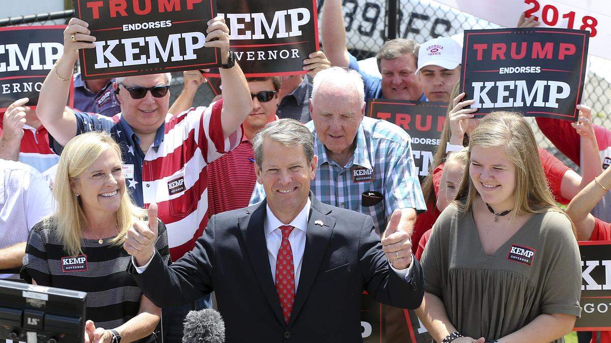 Secretary of State Brian Kemp, with his wife Marty and daughter Lucy, gives the double thumbs up making his first campaign stop during his Putting Georgians First Fly Around at Peachtree DeKalb Airport on Monday, July 23, 2018, in Atlanta. The state’s gubernatorial contest comes into greater focus Tuesday after Republicans choose between Kemp, who is endorsed by President Donald Trump, and Casey Cagle, who is backed by the incumbent GOP governor. (Curtis Compton/Atlanta Journal-Constitution via AP)