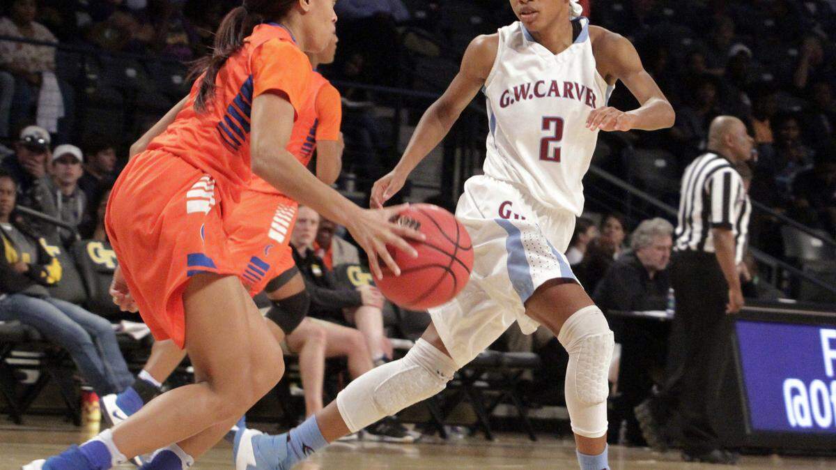 The Columbus High Lady Blue Devils win the GHSA Class AAAA state basketball championship 69-67 in overtime against Carver High at Georgia Tech Friday.