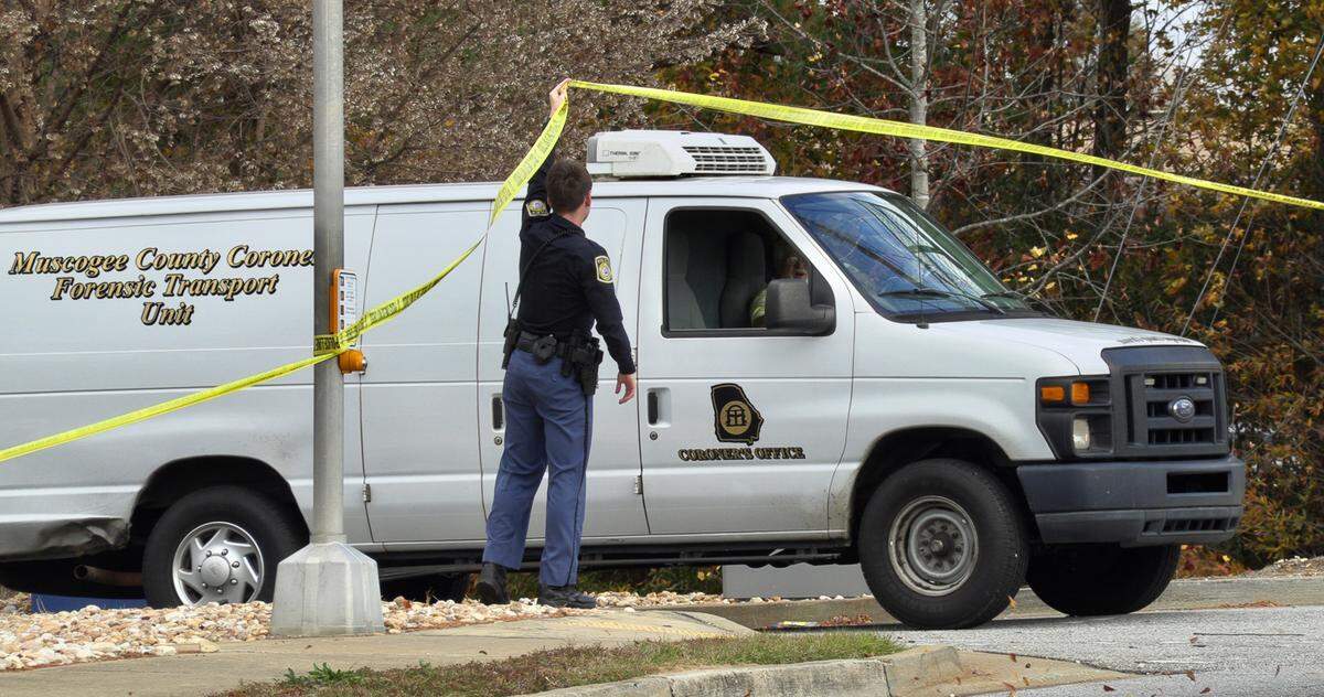 A Muscogee County Coroner’s Office van leaves the scene of a fatal shooting at the Synovus bank branch at 4505 Buena Vista Road