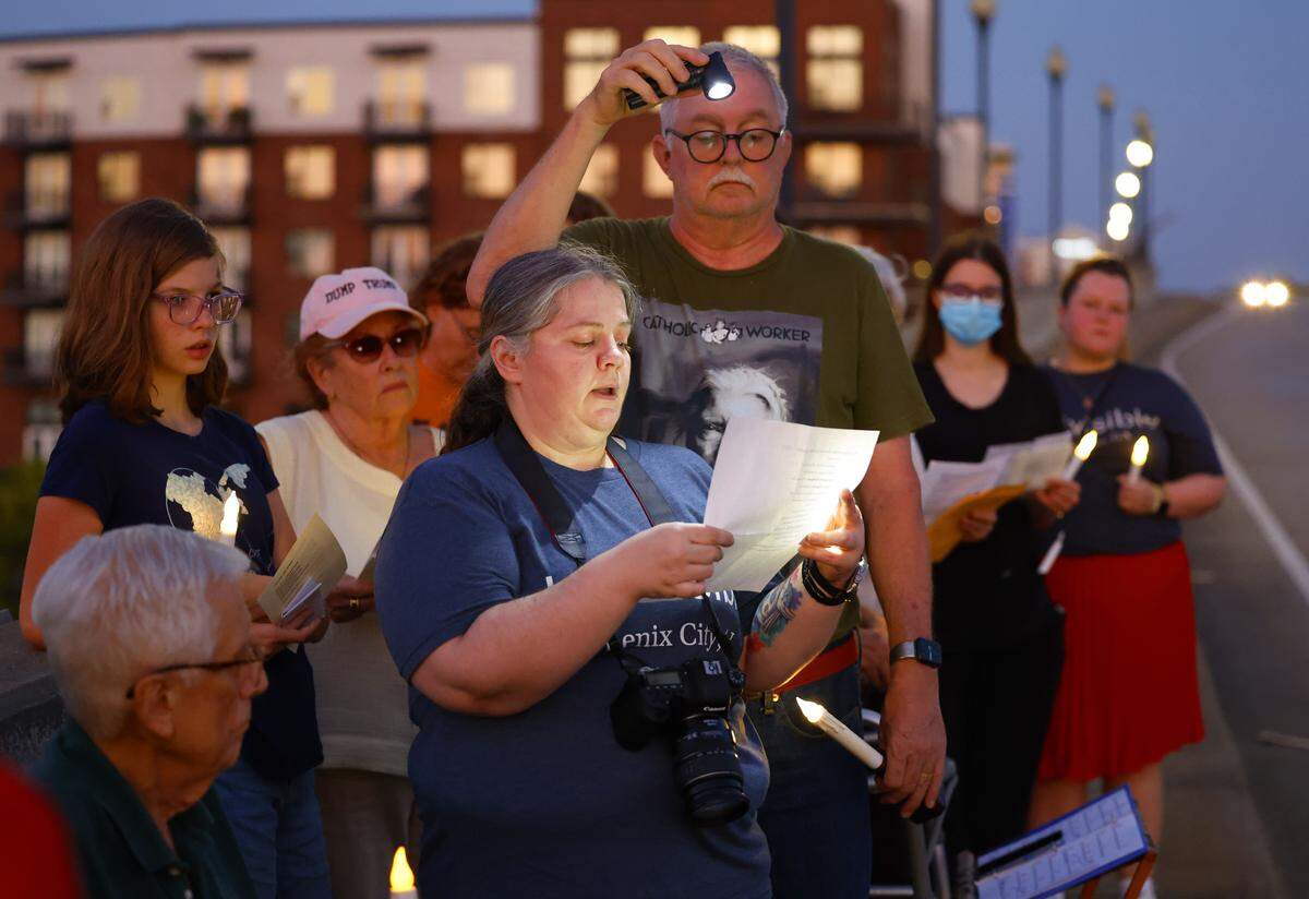 People gather Sept. 4, 2025, on the 13th Street Bridge, which connects Columbus, Georgia, to Phenix City, Alabama, for a candlelight vigil to remember and honor victims of gun violence. The event was organized by Phenix City Indivisible, Columbus, GA Indivisible and the Under the Muscadine Catholic Worker community.