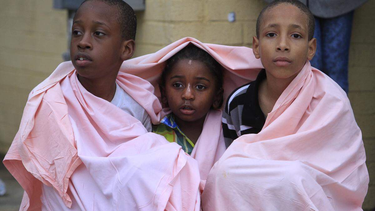 MIKE HASKEY/mhaskey@ledger-enquirer.comFrom left, Dayron Ewing, 8, Christopher Cody Jr., 3, and DeAnthony Kirkland, 10, try to stay warm after escaping the fire Tuesday afternoon. Twenty-four units were destroyed in an apartment fire on Martin Luther King Jr. Boulevard, Columbus Fire Marshal Ricky Shores said. No one was injured in the blaze at Boulevard Apartments on 1420 Martin Luther King Jr. Blvd. Columbus Fire & EMS was called to the scene just after 3 p.m. following a report of a fire on the bottom floor. Shores said the blaze quickly spread to the attic, completely destroying Building 1420. Go to www.ledger-enquirer.com for video from the fire.