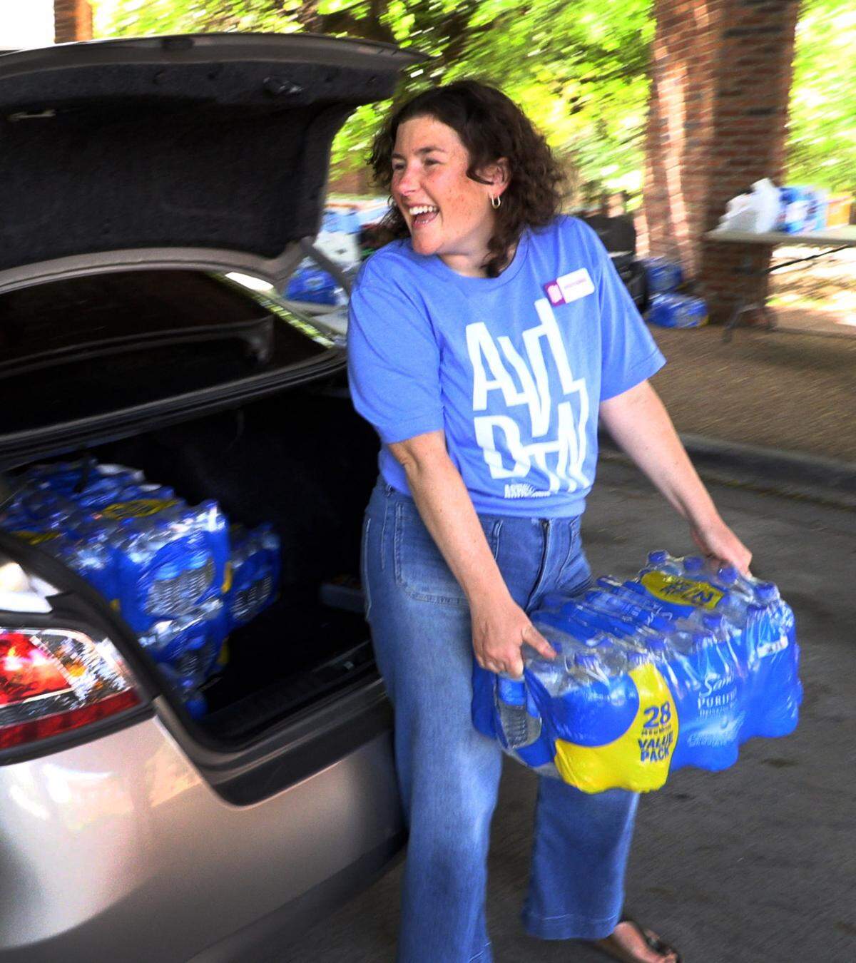 Hayden Plemmons, executive director of the Asheville Downtown Association in Asheville, North Carolina, unloads donated water from a car at the Columbus, Georgia Convention & Trade Center. 10/02/2024