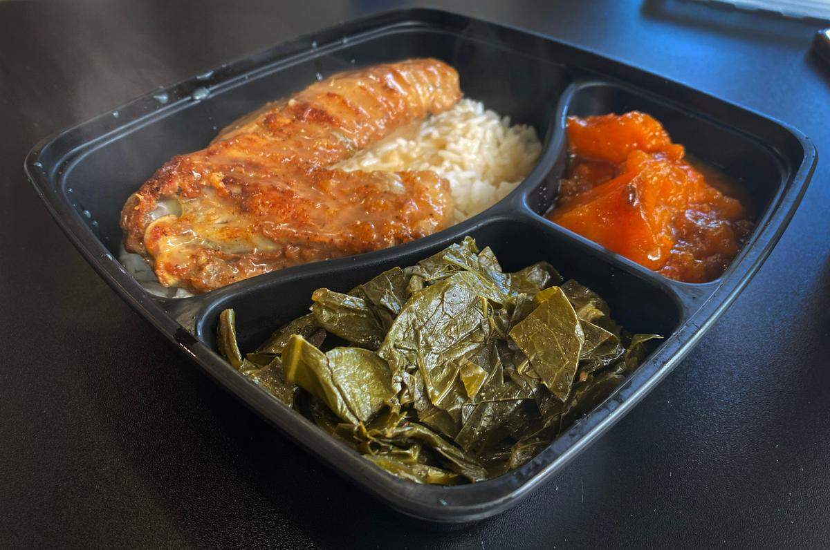 This is the turkey wing, served over rice, with side dishes of collard greens and sweet potatoes. 09/14/2023