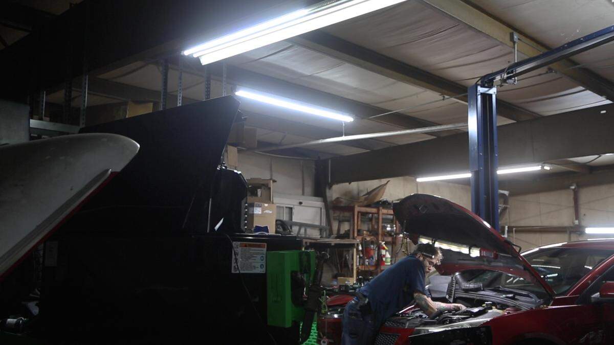 An employee works on a car at White’s Automotive Center, in Columbus, Ga. on Nov. 5, 2021.