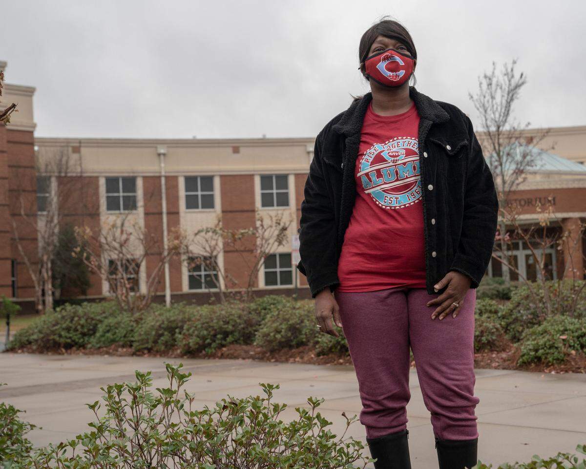 Tonza Thomas poses for a portrait at her alma mater Carver High School in Columbus, Ga, on Dec. 4, 2020. At the high school, she hosted a voter registration drive during a volleyball game.