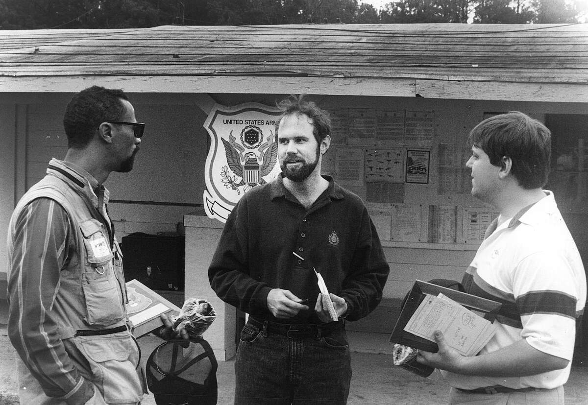 Tim Chitwood, center, speaks with WTVM cameraman Marion Lawhorn, left , WTVM sportscaster Dave Platta .