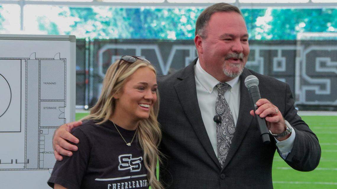 Smiths Station High School principal Adam Johnson calls forward Hayden Suggs, a star athlete at the school, to participate in the ribbon-cutting ceremony April 17, 2026, to celebrate completion of the school’s new Indoor MultiPurpose Athletics Complex.