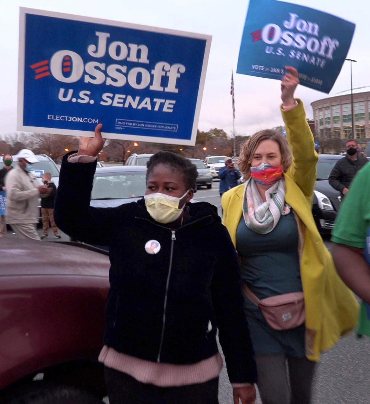 Nadratu Nuhu, left, and Joanna Mevers, cheer as John Ossoff takes the stages Wednesday. Ossoff campaigned Wednesday, Dec. 16, 2020, at the Columbus Civic Center in Columbus, Georgia. Ossoff is running against Republican incumbent Senator David Perdue for one of Georgia’s two seats in the U.S. Senate.