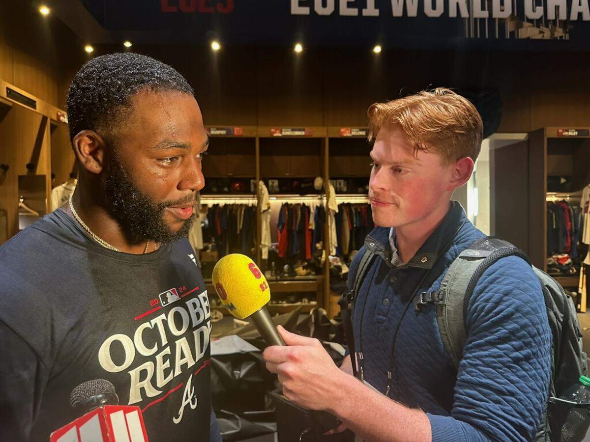 Jack Johnson, right, interviews Michael Harris II on Sept. 30, 2024. The Braves clinched a playoff spot that day, and Johnson was in the clubhouse doing postgame reporting for 680 The Fan. The Columbus Clingstones recently announced Johnson has been hired as the first lead broadcaster and play-by-play voice of the Atlanta Braves’ new Double-A franchise.
