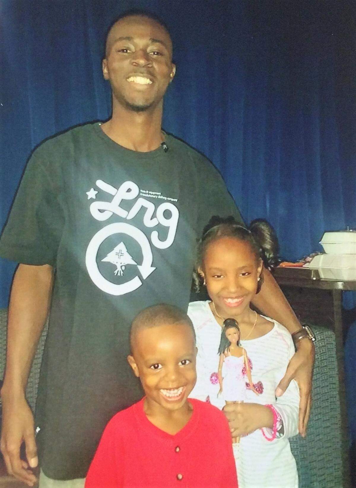 Quinton Moss poses in this 2016 photo with his niece Dasiah Garlic, 8, and nephew Josiah Garlic, 3.