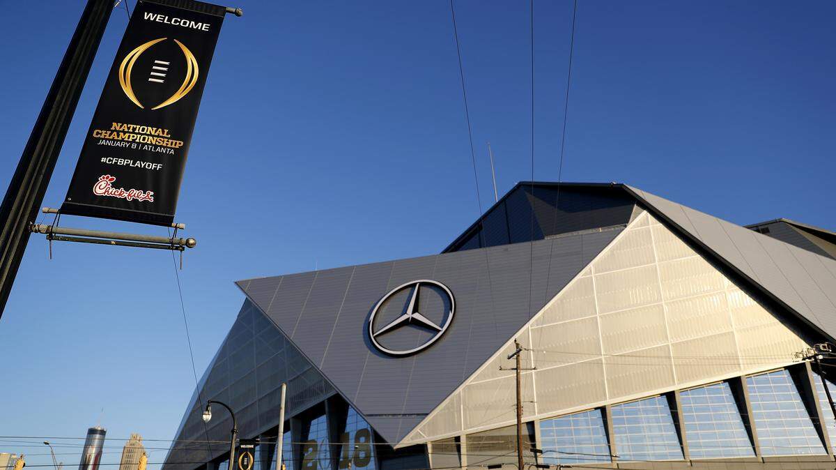 A banner for the college football championship game decorates a lamppost next to Mercedes-Benz Stadium where the game will be played, in Atlanta.