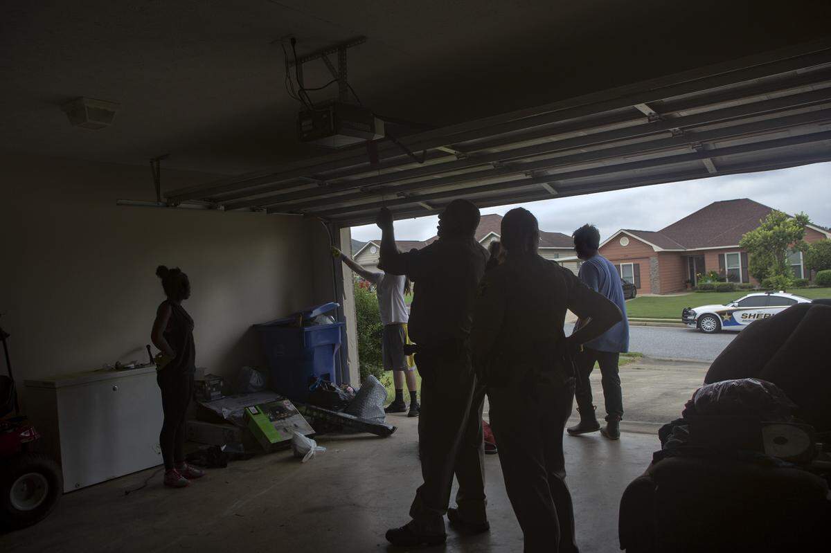 Deputies strategize with movers on the most efficient way to clear an evicted home on July 20, 2021, in Columbus, Ga.