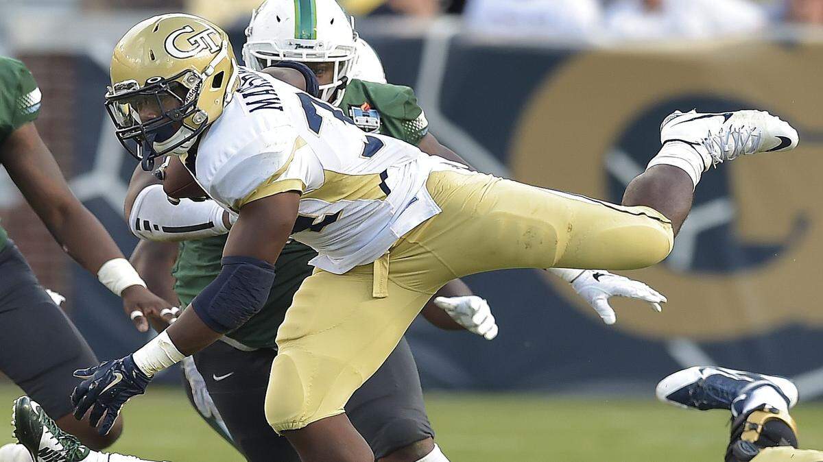 MIKE STEWART/Associated PressGeorgia Tech running back Marcus Marshall (34) leaps over Tulane linebacker Nico Marley (20) during the second half Saturday in Atlanta. Georgia Tech won 65-10.