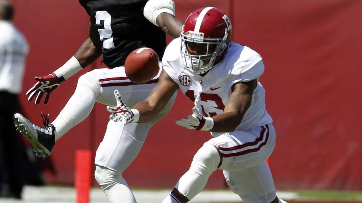Wide receiver ArDarius Stewart (13) catches a deflected pass over defensive back Tony Brown (2) during Alabama's A-Day NCAA college football spring game Saturday, April 19, 2014, in Tuscaloosa, Ala. (AP Photo/Butch Dill)