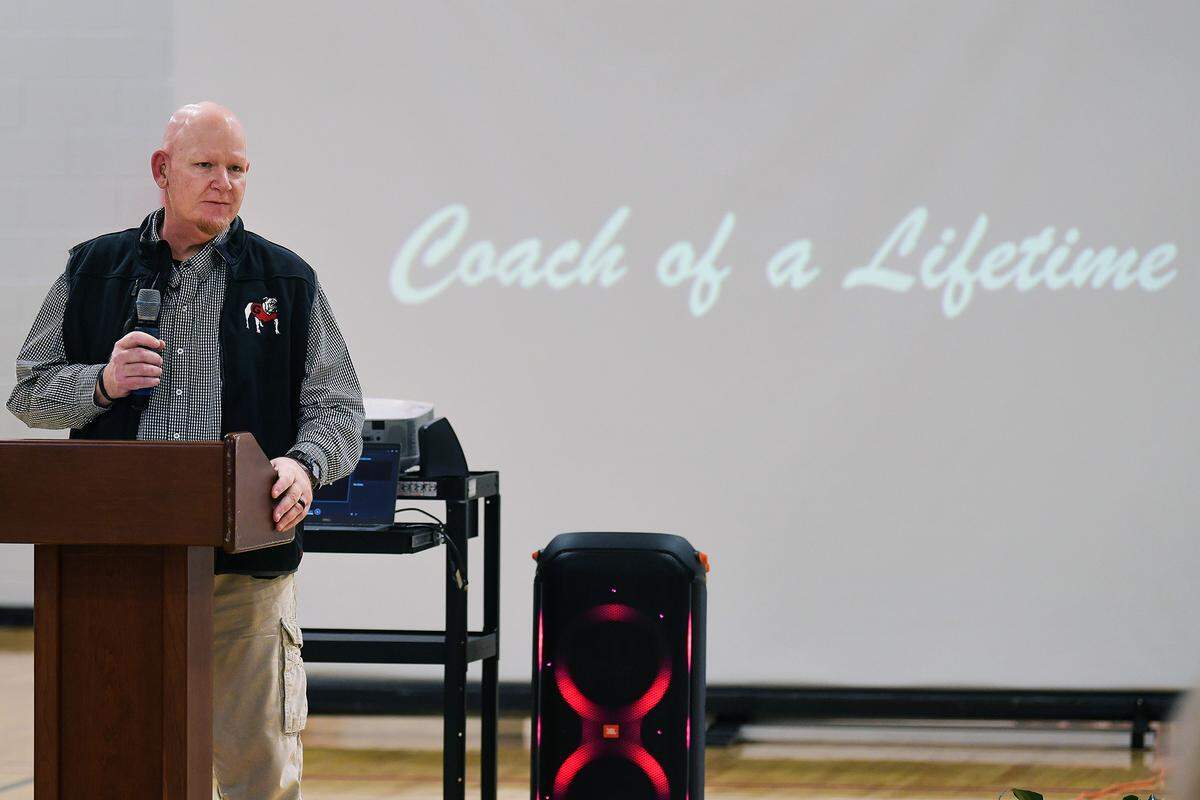 Coach Jay Wilson of Veterans Memorial Middle School in Columbus, Georgia greets guests, family and dignitaries for the dedication ceremony naming the school gymnasium’s court in his honor. 01/24/2024