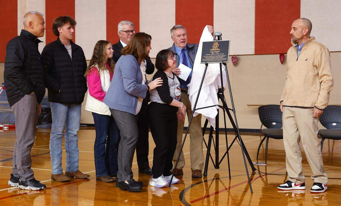 Columbus Mayor Skip Henderson looks on as the family of Angie Shehane unveils a plaque honoring her years of community service during a ceremony Thursday at the Pop Austin Recreation Center in Columbus, Georgia. 