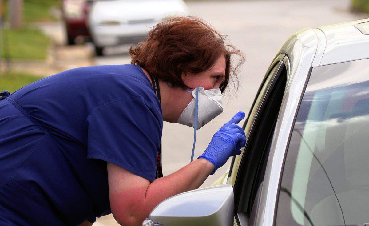 Mary Tien, a registered nurses with the Georgia Department of Public Health’s West Central Health District, screens a person who came to the drive-thru test collection site at 2100 Comer Avenue in Columbus, Georgia. The department, which covers Chattahoochee, Clay, Crisp, Dooly, Harris, Macon, Marion, Muscogee, Quitman, Randolph, Schley, Stewart, Sumter, Talbot, Taylor and Webster counties, got its first kits Wednesday.