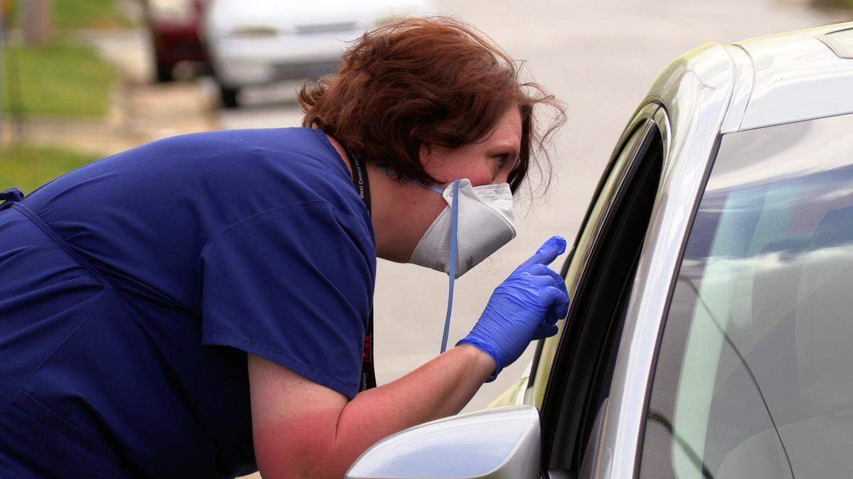 Mary Tien, a registered nurse with the Georgia Department of Public Health’s West Central Health District, screens a person who came to the drive-thru test collection site at 2100 Comer Avenue in Columbus, Georgia. The department, which covers Chattahoochee, Clay, Crisp, Dooly, Harris, Macon, Marion, Muscogee, Quitman, Randolph, Schley, Stewart, Sumter, Talbot, Taylor and Webster counties, got its first kits Wednesday.