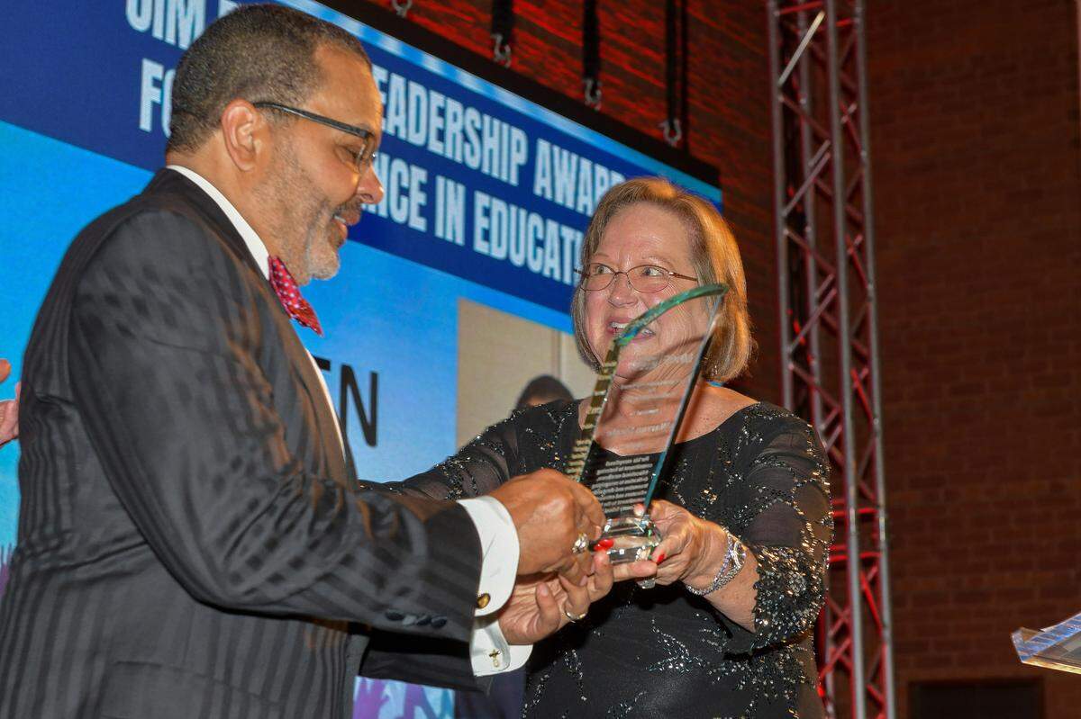 Warren Steele receives the Jim Buntin Leadership Award from Janet Davis during the Muscogee Educational Excellence Foundation gala May 9, 2024, in the Columbus Convention & Trade Center.