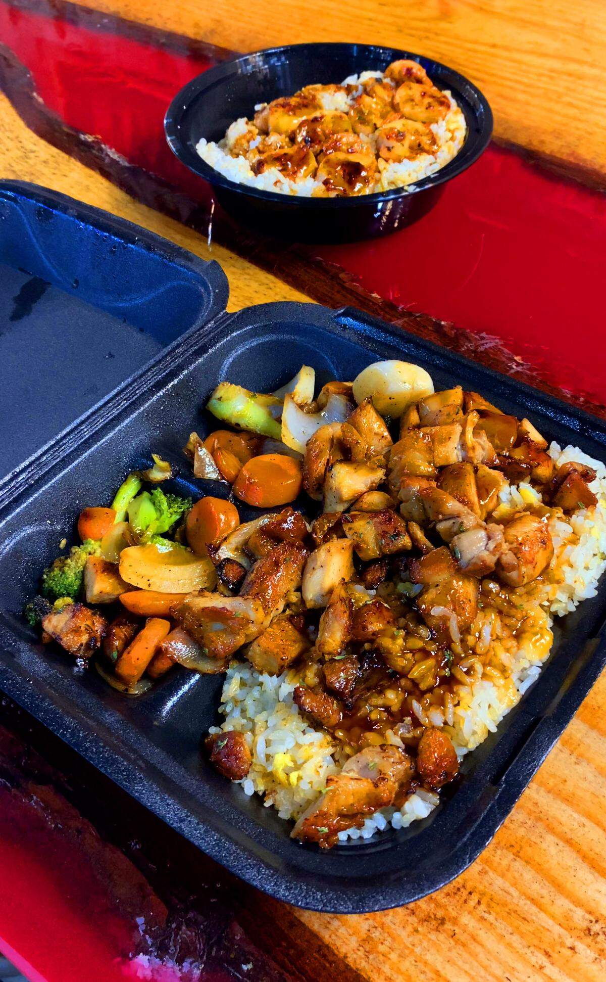 Ledger-Enquirer photographer Mike Haskey ordered Teriyaki Chicken, front, and reporter Kelby Hutchison ordered the Hibachi Bowl with shrimp, rear from Taste of Tokyo at 1056 Manchester Expressway in Columbus, Georgia.. 05/09/2025