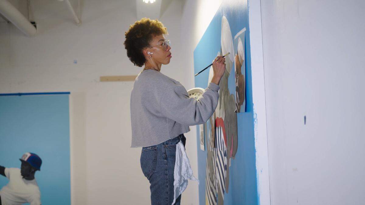 Acclaimed artist and Columbus native Amy Sherald is shown at work in her studio.