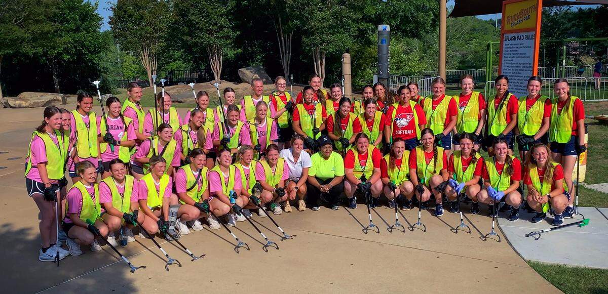 College softball players in Columbus for the 2026 NAIA Softball World Series swapped their softball gloves for disposable gloves May 20, 2026, to beautify the Chattahoochee Riverwalk. Players and coaches from two schools, the University of the Cumberlands in Williamsburg, Kentucky, and Marian University in Indianapolis scoured the Riverwalk for trash, debris and litter as part of the Champions of Character Cleanup effort organized by the Keep Columbus Beautiful Commission and the Columbus Sports Council.
