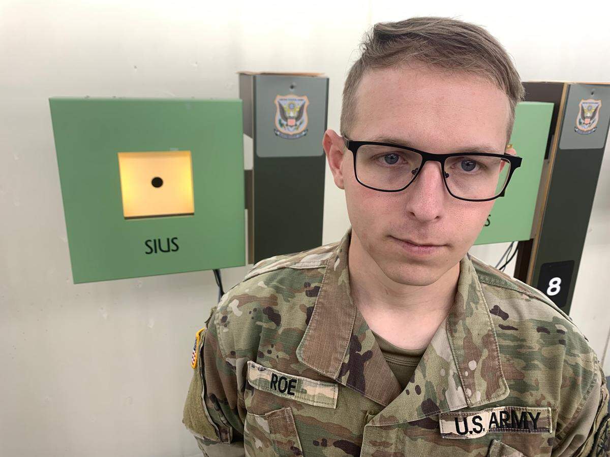 Sgt. Ivan Roe stands in front of 10 meter air rifle targets at a training facility located at Fort Moore. Roe recently made Team USA for the 2024 Olympics. He will be competing in the 10 meter air rifle event.