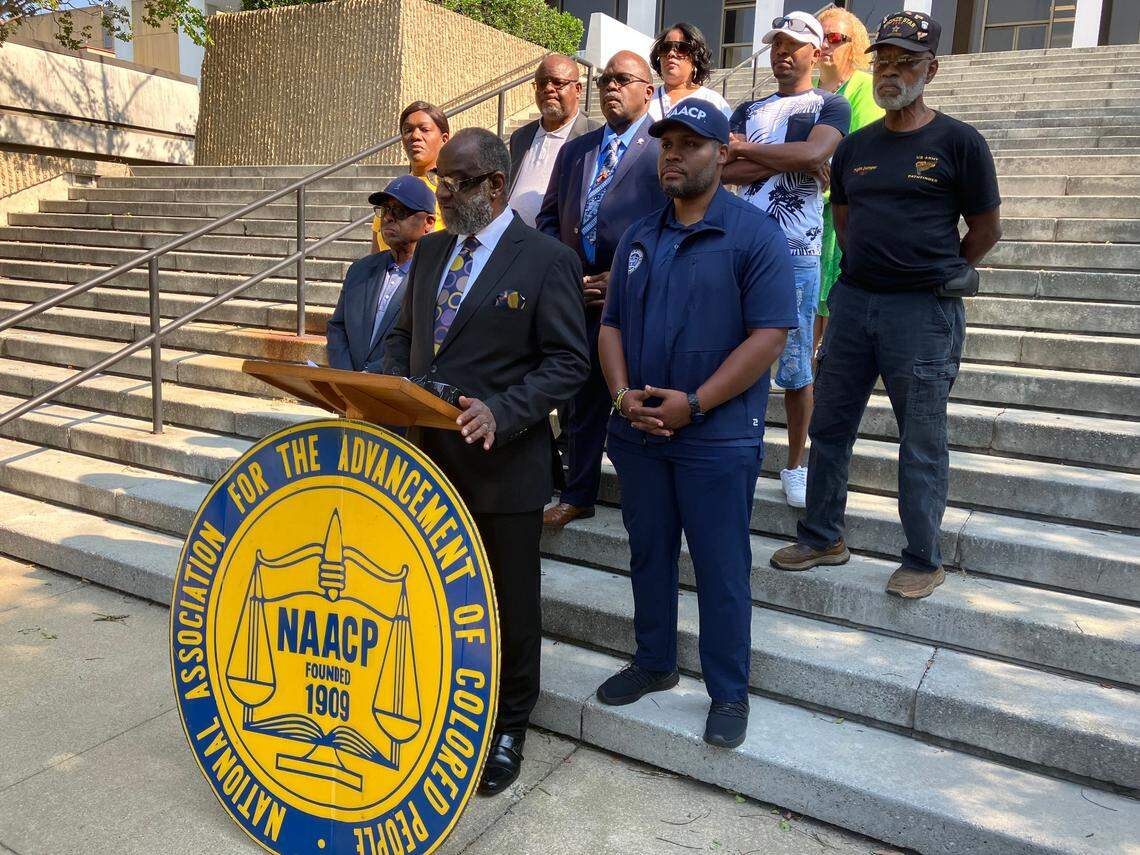 NAACP officials and supporters gather June 10, 2023, at the steps of the Columbus Government Center for a news conference announcing their condemnation of city and Georgia Republican Party officials for allowing former president Donald Trump to speak at the GOP state convention in the Columbus Convention & Trade Center despite being charged with federal crimes. Columbus NAACP branch president Wane Hailes is at the podium.