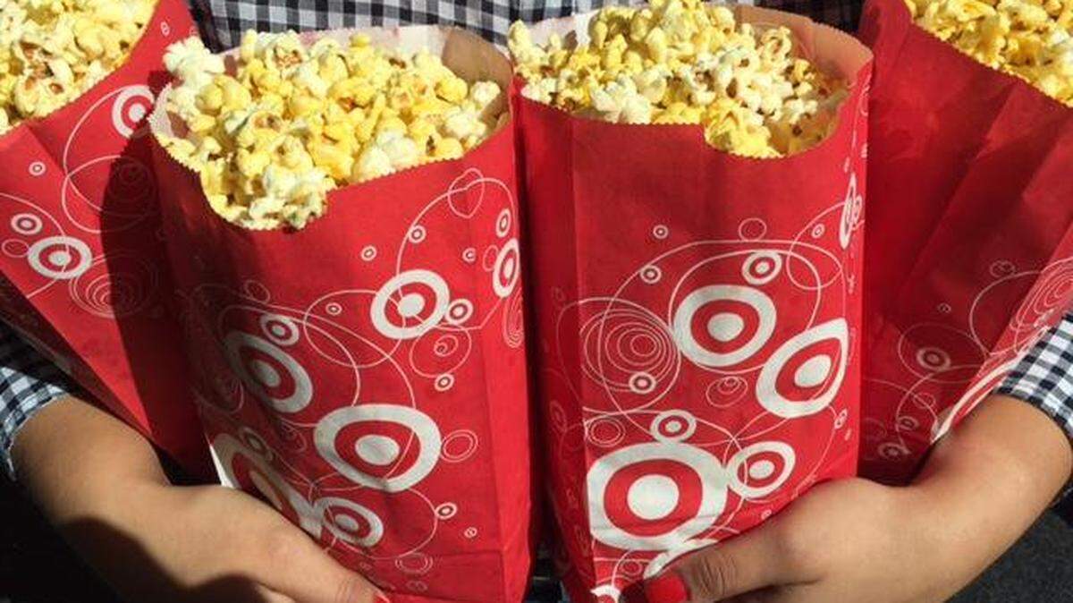 A major fan of Target’s popcorn clutches several bags of the snack, which some shoppers enjoy with slushy Icee refreshments. --