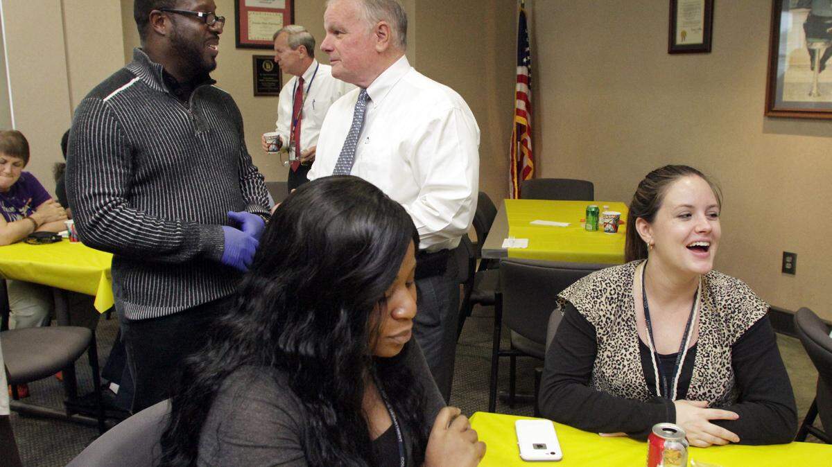 Photos by ROBIN TRIMARCHI/rtrimarchi@ledger-enquirer.comThe Rev. Prathan Powell, left, of World Changes Tabernacle Church talks with Columbus Police Chief Ricky Boren during a lunch for law enforcement officers at the Public Safety Building. Volunteers from 10 area churches joined Powell in serving barbecue sandwiches and refreshments to officers and their staff.