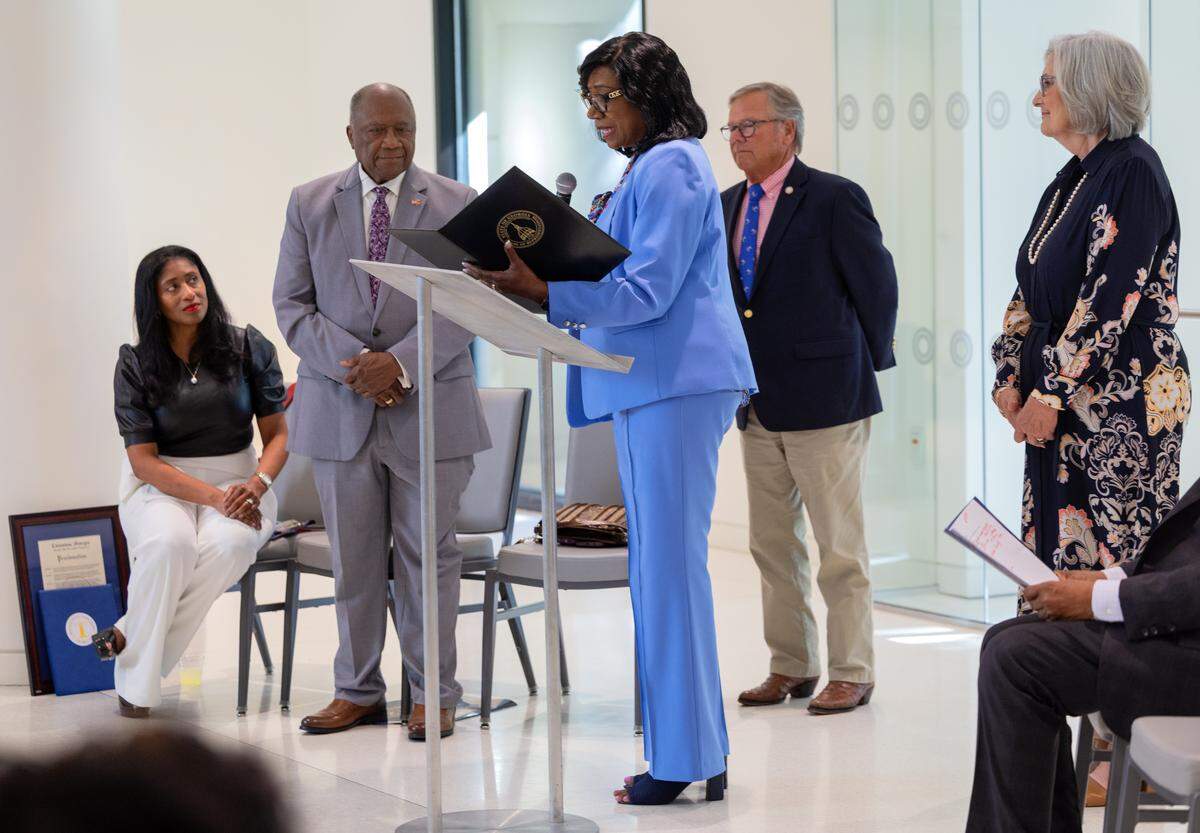 State Rep. Carolyn Hugley (D-Columbus), center, speaks in honor of state Sen. Ed Harbison (D-Columbus) June 4, 2026, at the Columbus Museum. The Columbus area’s state legislative delegation and former state Rep. Calvin Smyre (D-Columbus), hosted the reception for Harbison, a state senator for the past 33 years, who announced in March he wouldn’t seek reelection.