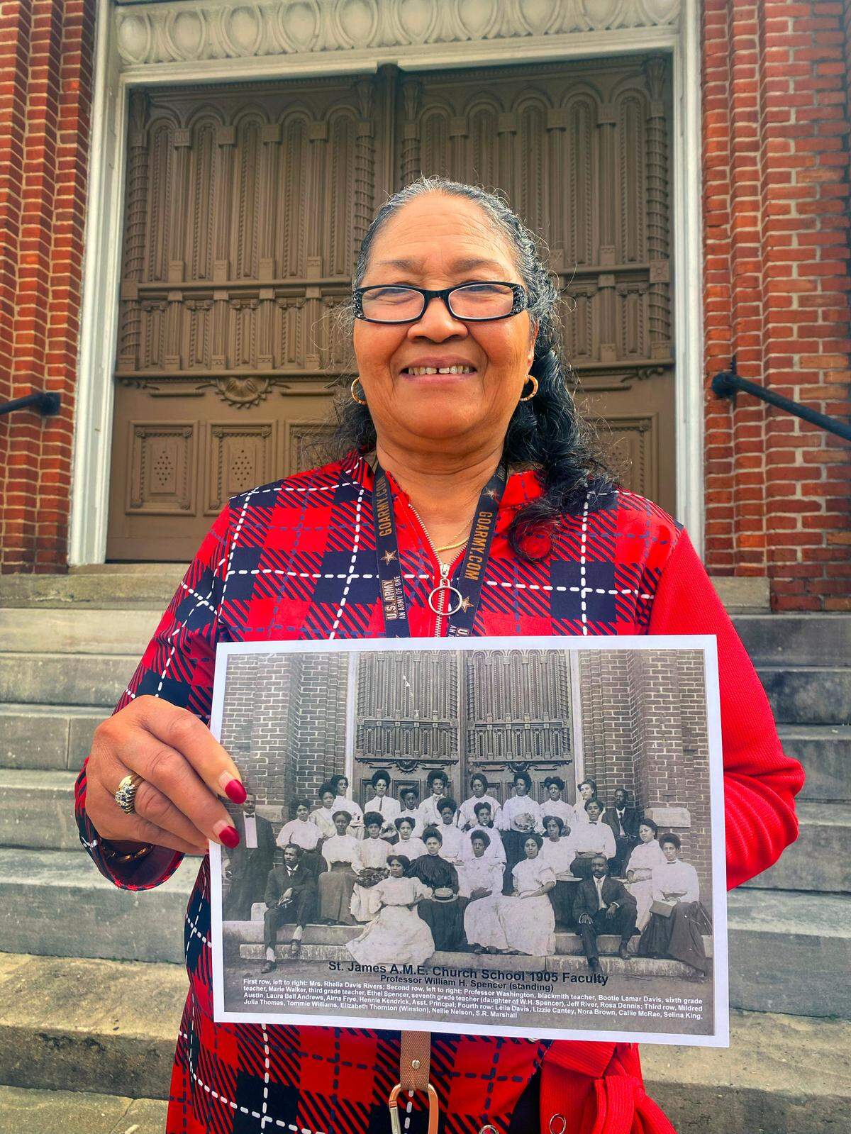 Carolyn Hensley, the church historian at Saint James A.M.E. Church in Columbus, Georgia, holds a photograph of the 1905 faculty of the church’s school. 02/16/2024