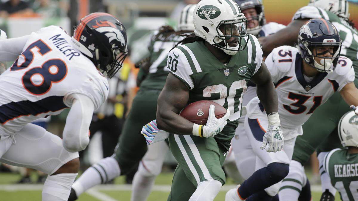 New York Jets’ Isaiah Crowell (20) rushes past Denver Broncos’ Von Miller (58) during the first half of an NFL football game Sunday, Oct. 7, 2018, in East Rutherford, N.J.